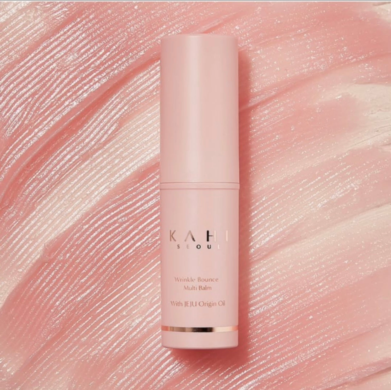 Pink skincare bottle with 'Kahi' branding on a textured pink background