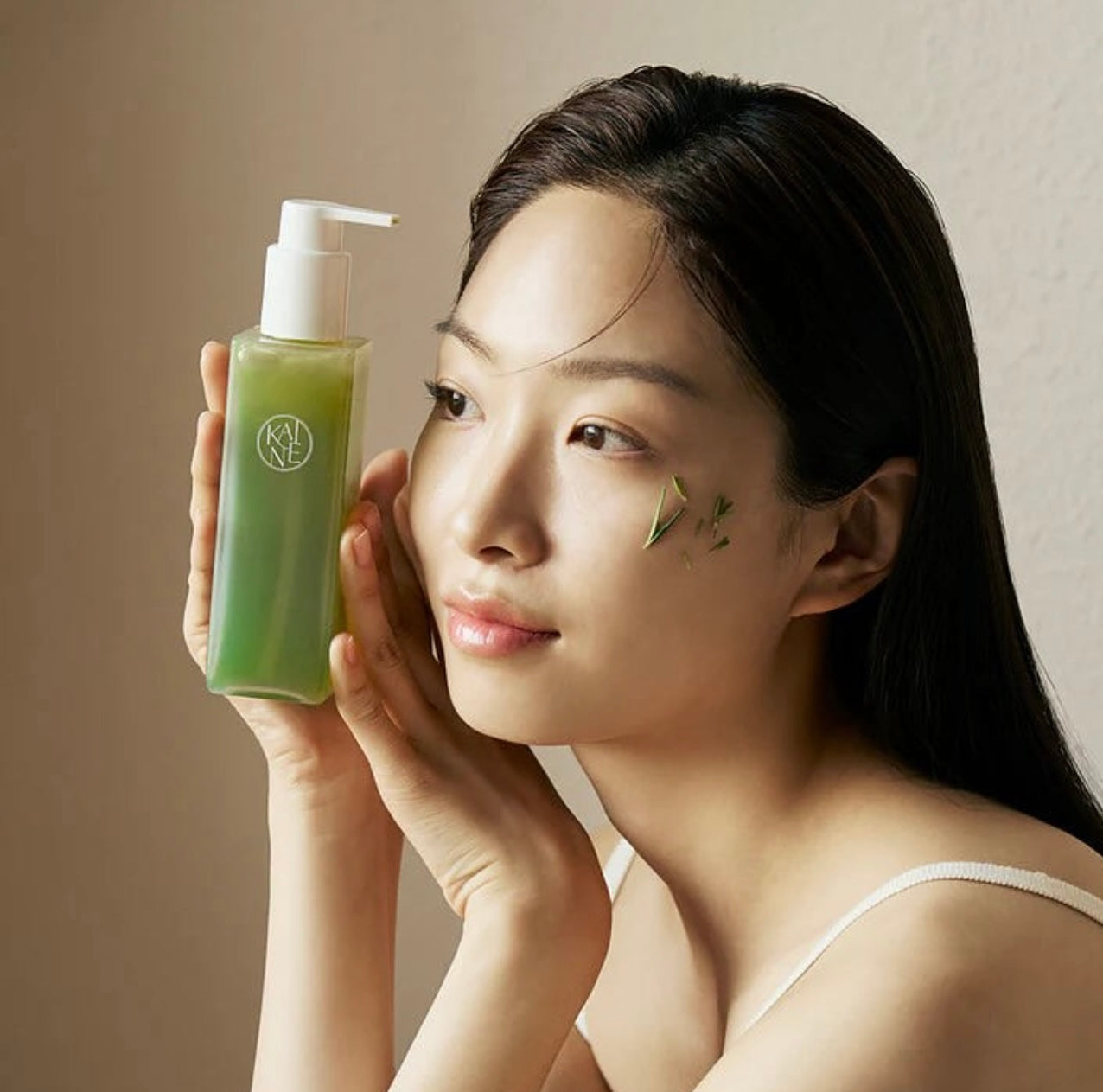 Woman holding Kaine Rosemary Relief Gel Cleanser 150ml