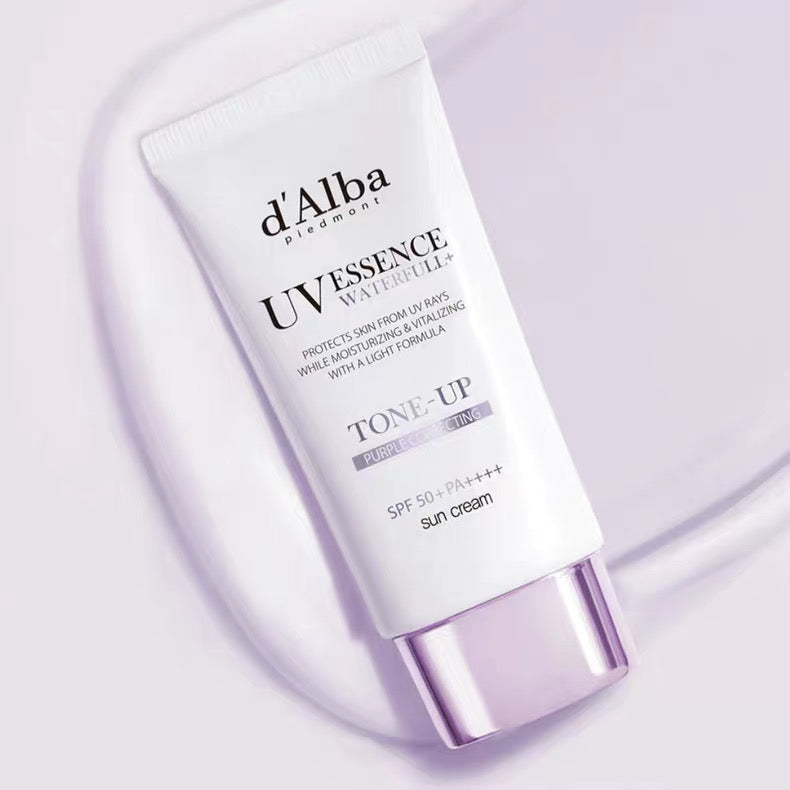 d'Alba UV Essence Waterlotion tube on a light purple background