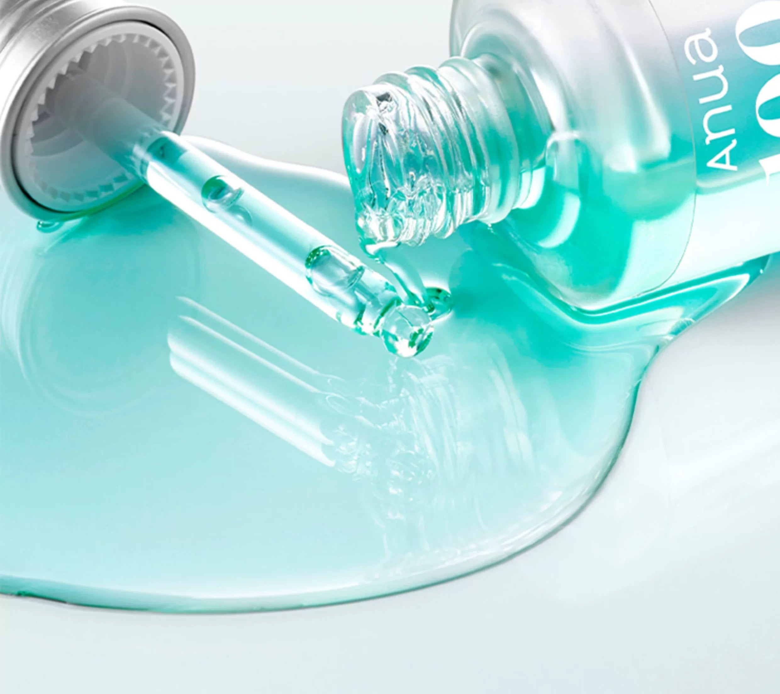 Close-up of a dropper with teal liquid on a white background, featuring the product 'Anua 100+ PDRN + Hyaluron Serum 30ml'.
