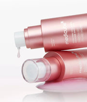 Two Medicube PDRN Pink Collagen Exosome Shot 2000 30ml with droplets of product on a white background