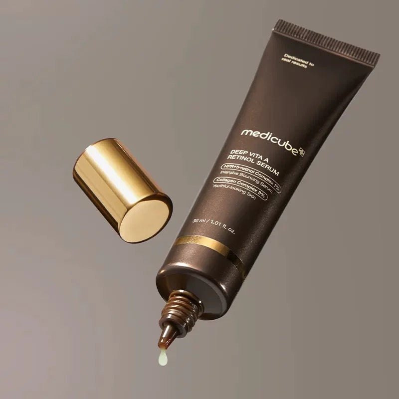Medicube Derm Vita A Retinol Serum tube with dropper on a gray background